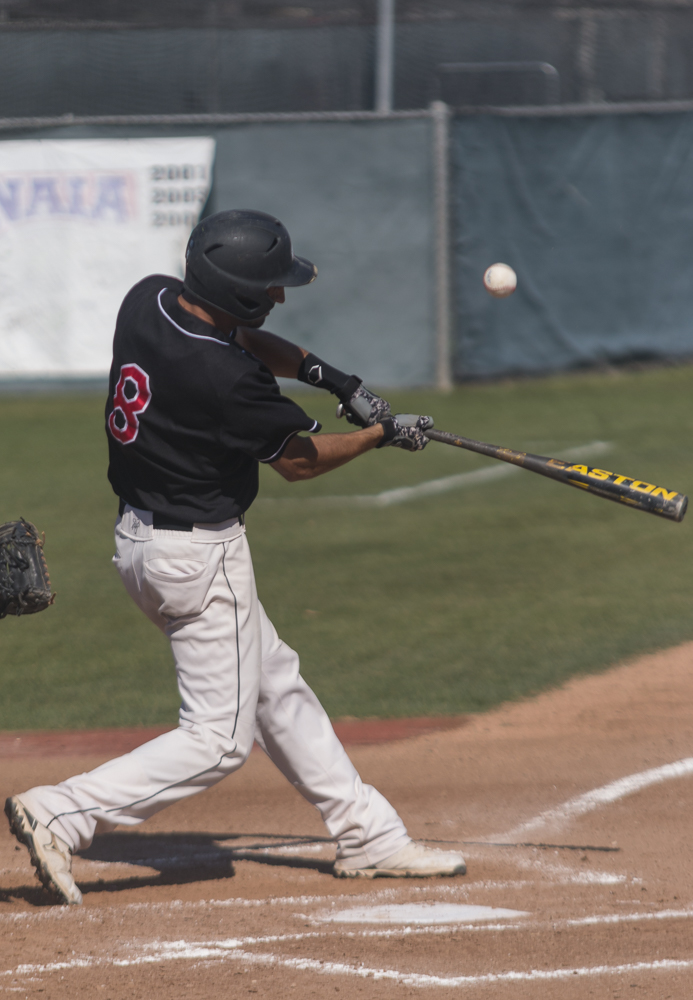 Senior Tanner Swire swings at a pitch against The Master's College on March 21. | Aaron Fooks/THE CHIMES [file photo]