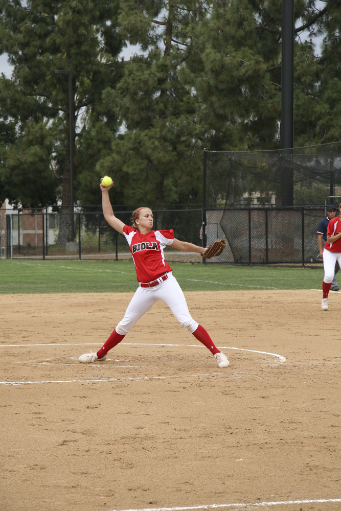 Sophomore right-handed pitcher Kimmy Triolo prepares a pitch against Concordia University on April 21. | Melissa Osswald/THE CHIMES [file photo]
