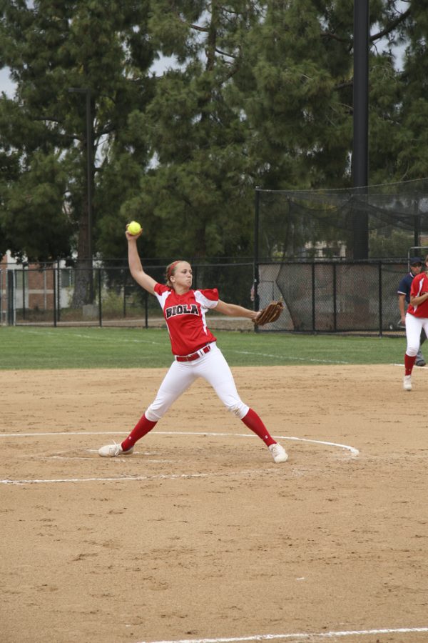 Sophomore right-handed pitcher Kimmy Triolo prepares a pitch against Concordia University on April 21. The Biola softball team finished Game 1 of the Softball GSAC 2015 Tournament. . | Melissa Osswald/THE CHIMES [file photo]
