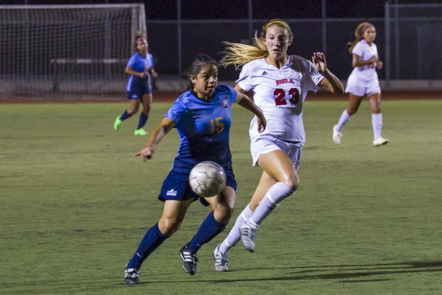 Junior Taylor Venegas pushes her way towards the ball in the heat of Biolas home game last week. | Matthew Matiz/THE CHIMES