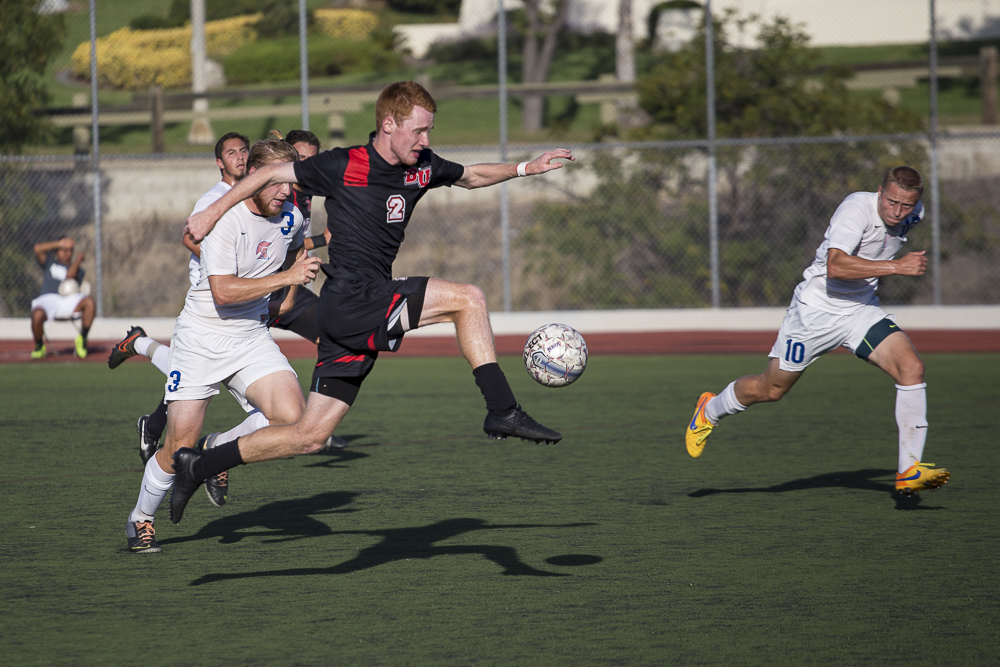 Senior John Hanscom leaps for the ball, stealing it from his opponent. | Matthew Maitz/THE CHIMES