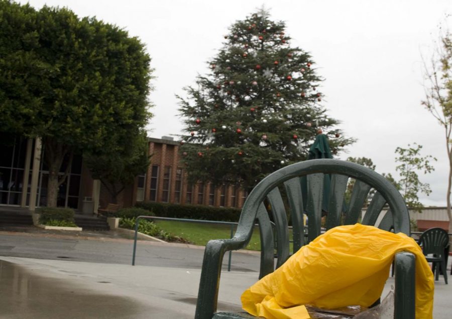 The yellow suits that kept workers dry while preparing Friday morning for the annual Christmas tree lighting lay scattered around the decorated tree on Friday afternoon. The event has been rescheduled for Monday night.