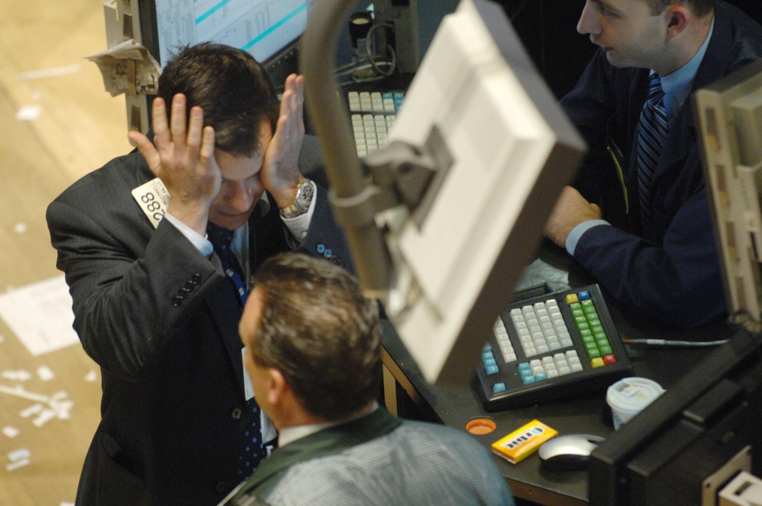 Michael McDonnell, left, rubs his eyes at the New York Stock Exchange Wednesday. Thursday's investment seminar instructed Biolans how to work the stock exchange and other investments for retirement.