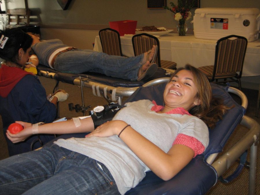 Junior Patty Solinap donates a pint during Wednesday's blood drive in the cafe banquet room.