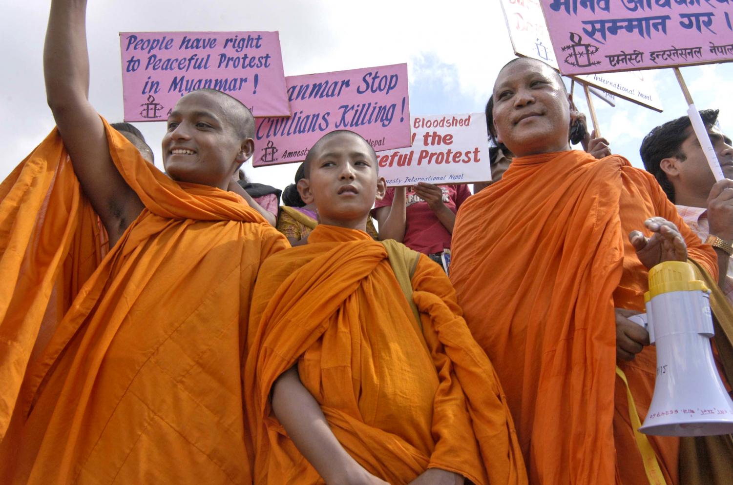 Nepalese Buddhist monks hold placards as they protest against the Myanmar military government in Katmandu, Nepal, Monday, Oct. 1, 2007.