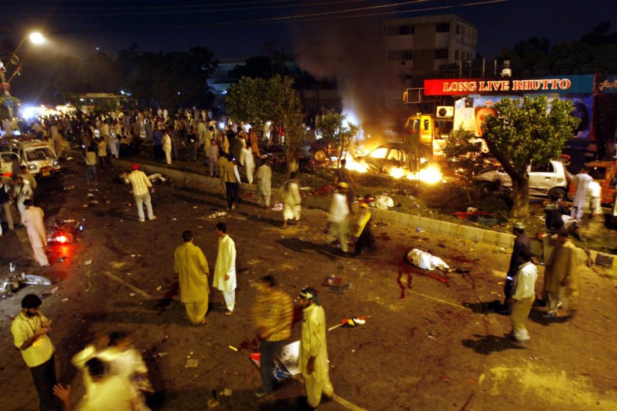 The+scene+of+devastation+caused+by+a+bomb+explosion+at+a+procession+of+Pakistans+former+Prime+Minister+Benazir+Bhutto+in+Karachi%2C+Pakistan+on+Thursday%2C+Oct+18.+Bhutto+was+unhurt.