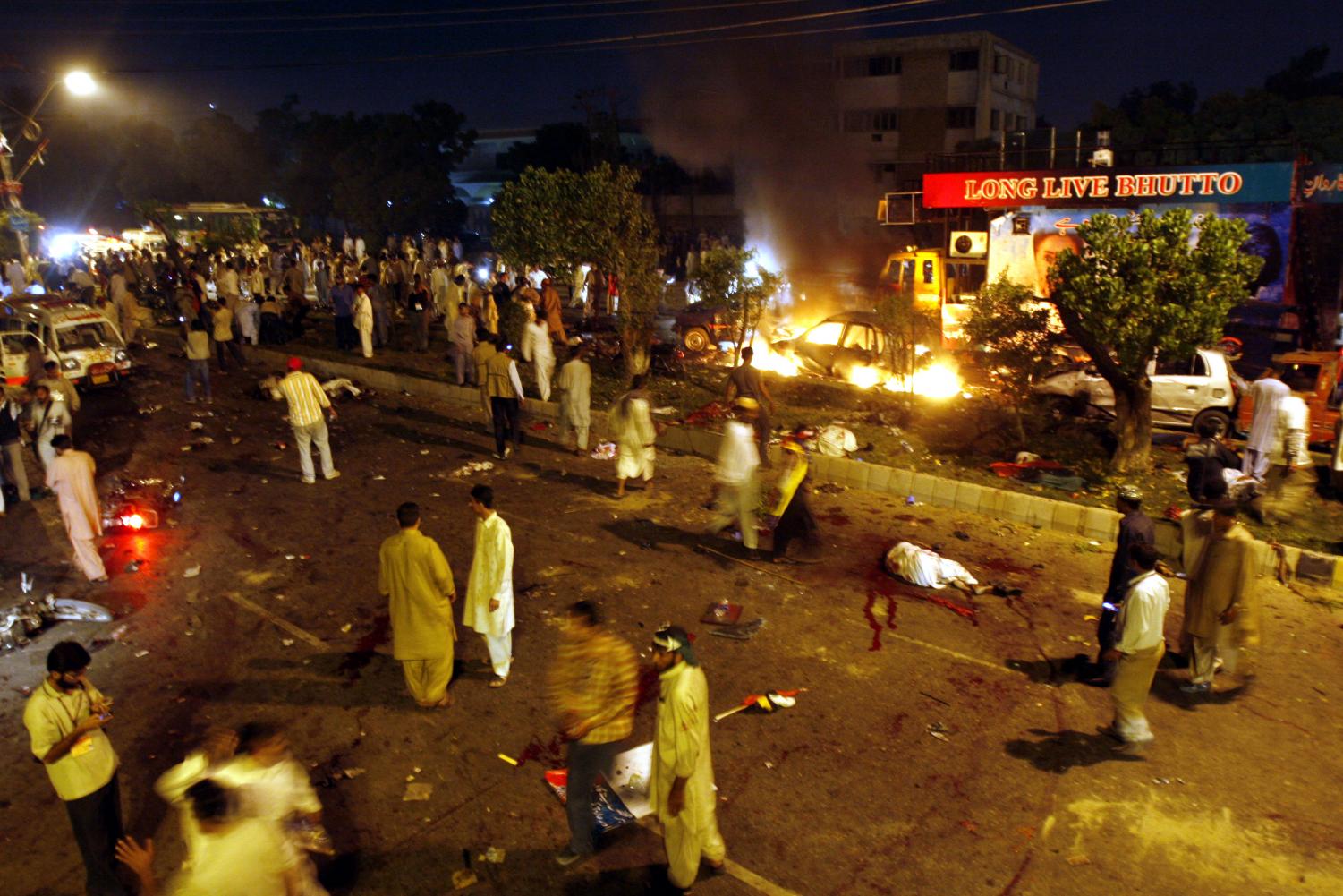 The scene of devastation caused by a bomb explosion at a procession of Pakistan's former Prime Minister Benazir Bhutto in Karachi, Pakistan on Thursday, Oct 18. Bhutto was unhurt.