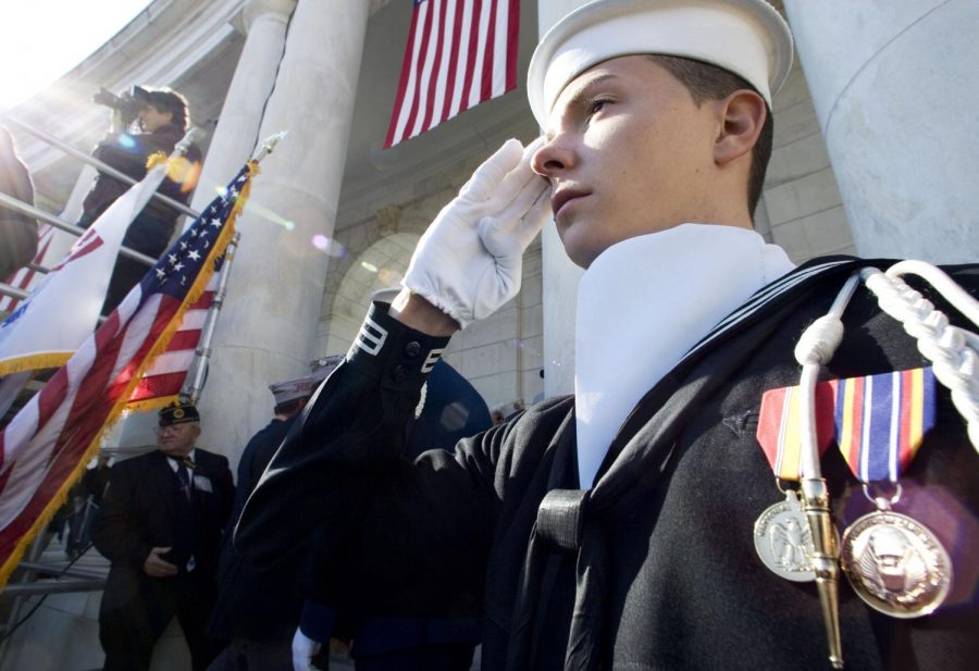 U.S.+Navy+sailor+Clifford+Mann+Jr.+salutes+as+the+colors+are+retired+during+a+Veterans+Day+commemoration+at+Arlington+National+Cemetery%2C+Sunday.