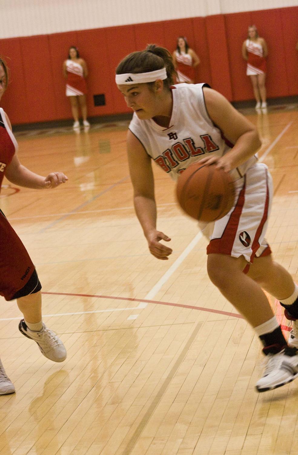 Sophomore guard Elise Paty drives to the basket in a home exhibition game against Melbourne Roos at the start of the season. The women’s basketball team returns home for a four-day stand beginning Thursday the 29th.