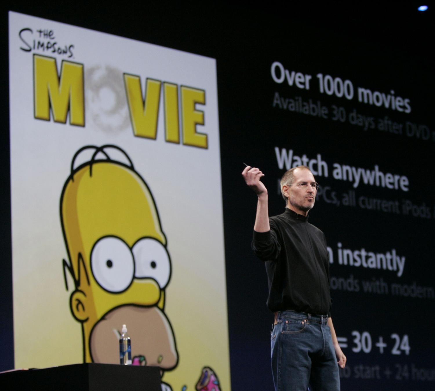 Apple CEO Steve Jobs gestures as he talks about online movie rentals during his keynote at the MacWorld Conference in San Francisco, Tuesday, Jan. 15, 2008.