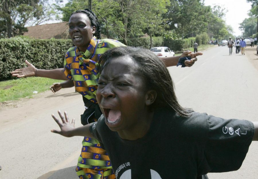 Woman cry outside the house of opposition lawmaker Mugabe Were where he was gunned down, early Tuesday, Jan. 29, 2008 in Nairobi. Two gunmen killed Were in an attack that almost immediately stoked the ethnic fighting that has gripped Kenya since last month's disputed presidential election.