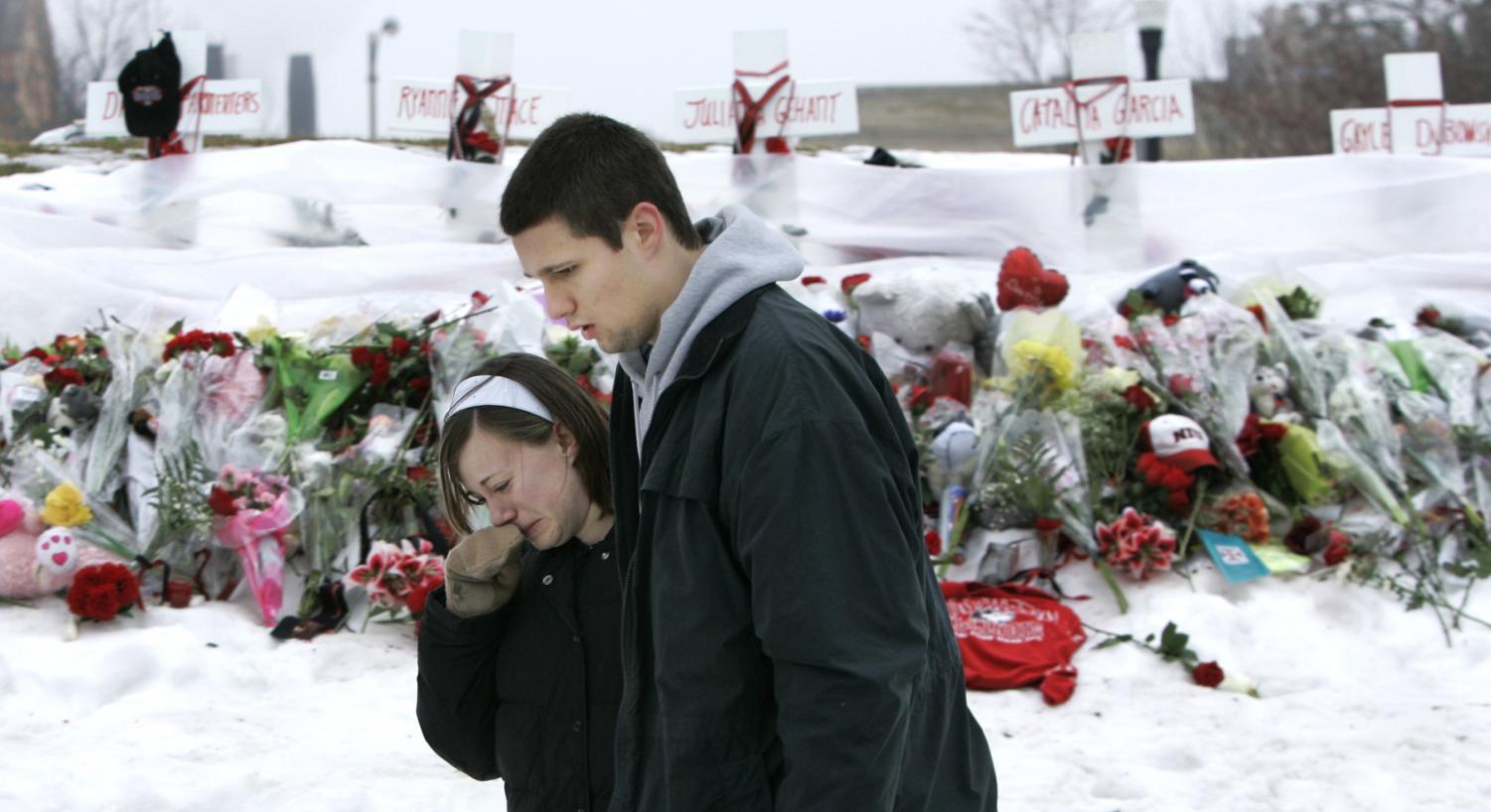 Mourners at Northern Illinois University console each other after placing flowers at a memorial for the five victims of the Valentines Day shooting on the campus of NIU in DeKalb, Ill., Sunday, Feb. 17, 2008. (AP Photo)