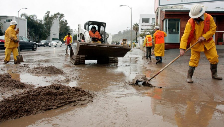 California Department of Transportation workers clean up Pacific Coast Highway in Malibu from mud and rain after fast-moving thunderstorms resumed their assault on Southern Calif., Jan. 27, 2008.