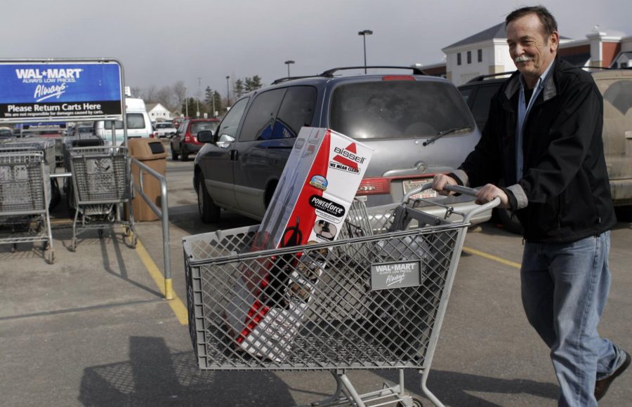 A shopper walks to his car at a Wal-Mart Store in Brunswick, Maine, on Tuesday, Feb. 19, 2008. The worlds largest retailer announced its renewed focus on low prices has paid off with a 4-percent rise in profit for its fourth quarter. (AP Photo)