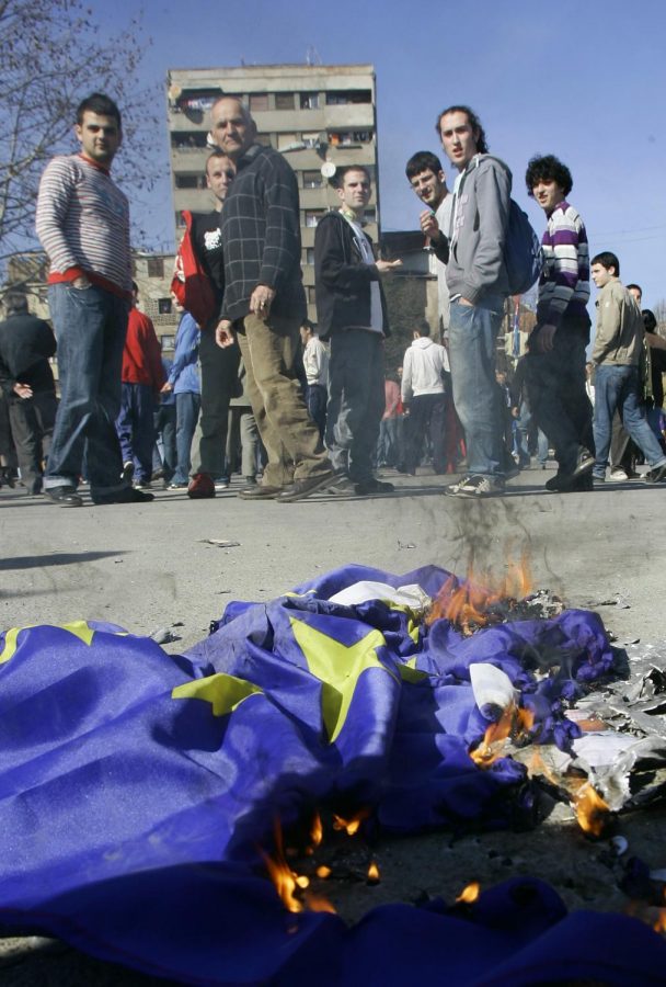 Kosovo Serbs watch a burning EU flag, during a protest against the independence of Kosovo, Monday, Feb. 25, 2008, near the key bridge between two parts of the ethnically divided town of Kosovska Mitrovica. Kosovo Serb protesters rallied against Kosovo's independence in the new nation's tense north, and a few set fire to EU flags in what has become a daily challenge of the country's secession from Serbia.