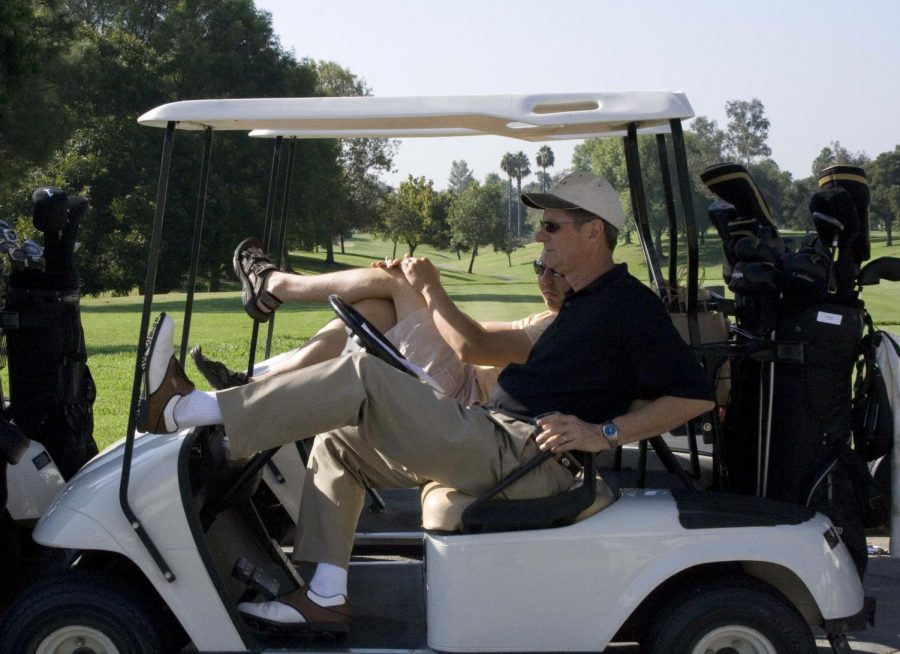 Golfers relax in carts before teeing off at Los Coyotes Country Club.