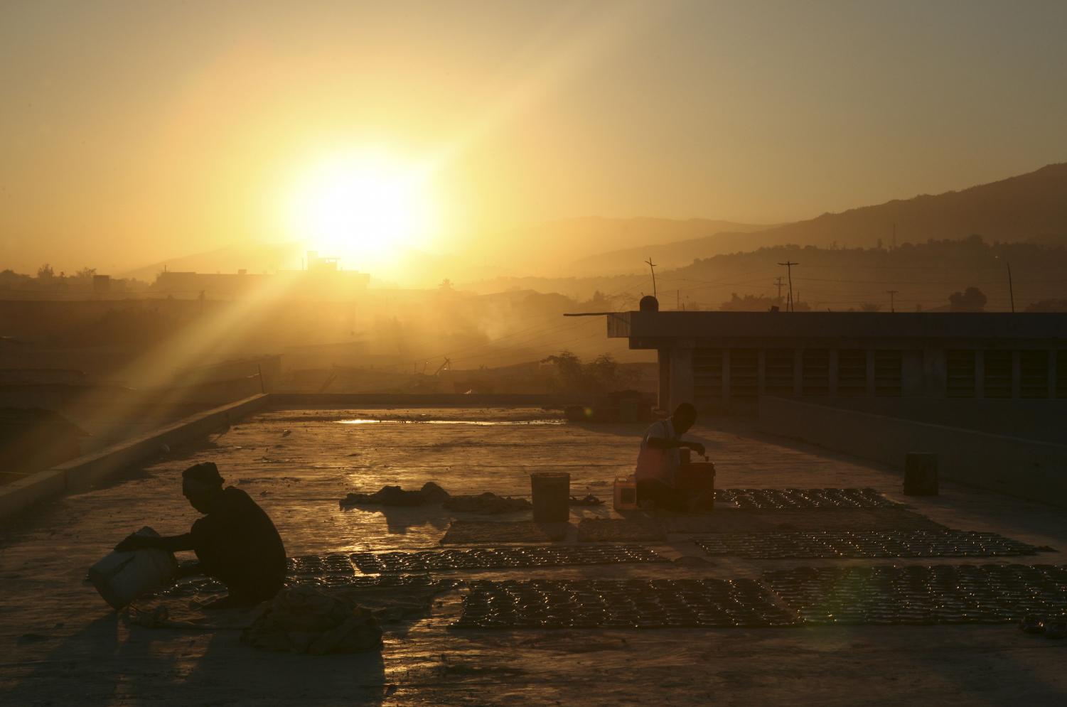 People prepare mud cookies on the the roof of Fort Dimanche, once a prison, in Port-au-Prince. Rising prices and food shortages threaten the nation's fragile stability. The ONE campaign aims to reduce hunger in countries like Haiti.