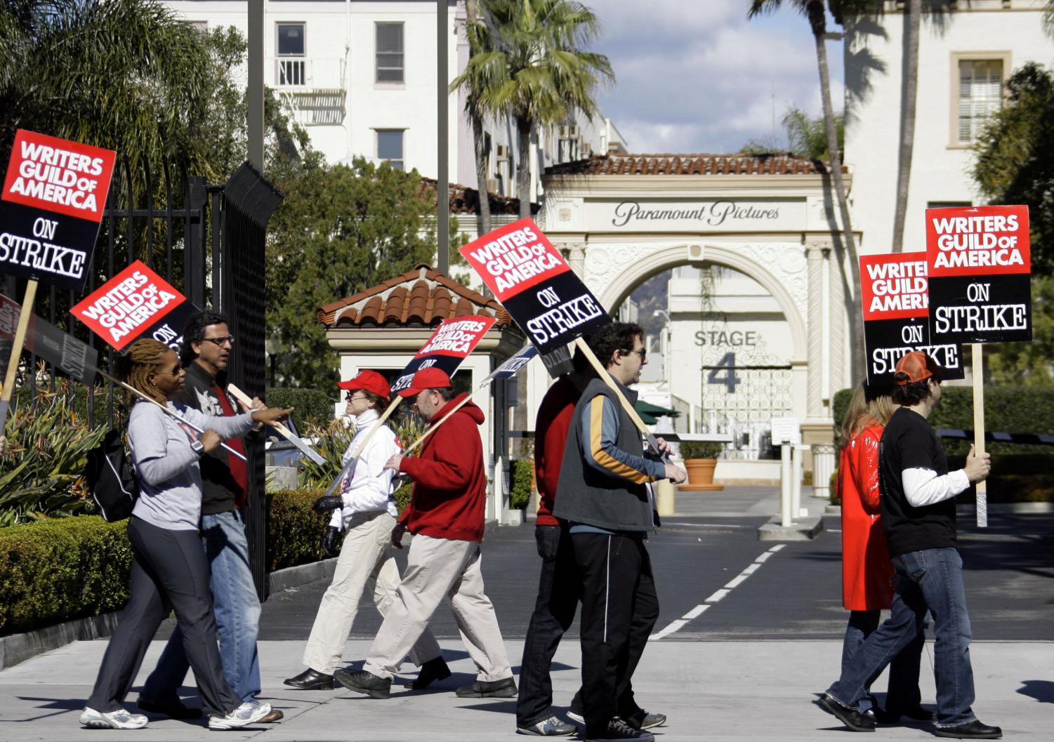 Writers guild members picket outside Paramount Studios in Los Angeles Monday, Feb 4. 2008. A person familiar with negotiations says the striking Hollywood writers guild remains on track for a possible deal with studios, but specific language of a new contract has yet to be resolved.