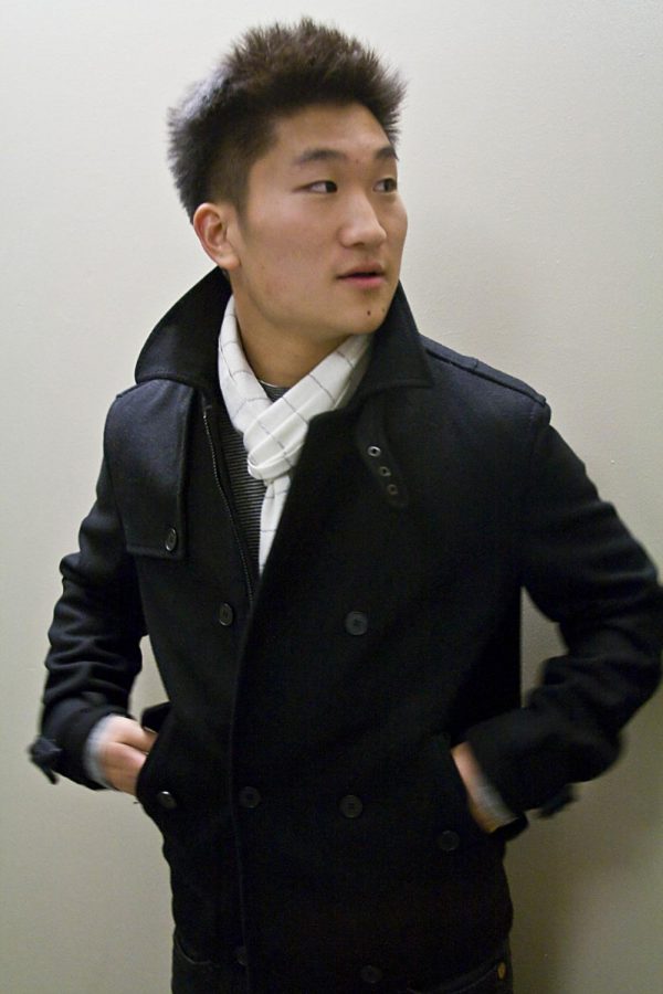 Daniel Han dresses in a black jacket and trendy scarf.