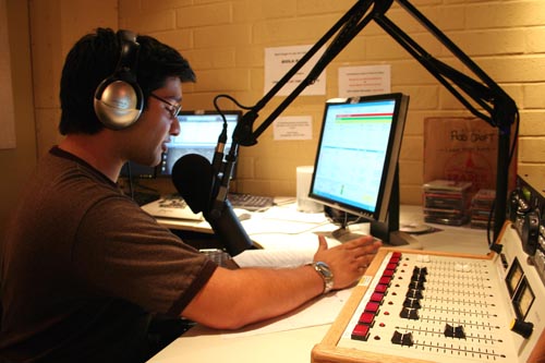 Senior Rudy Ramirez broadcasts at Biola Radios on-campus studio on Monday night. Several students have launched their own news and sports shows through the online station.