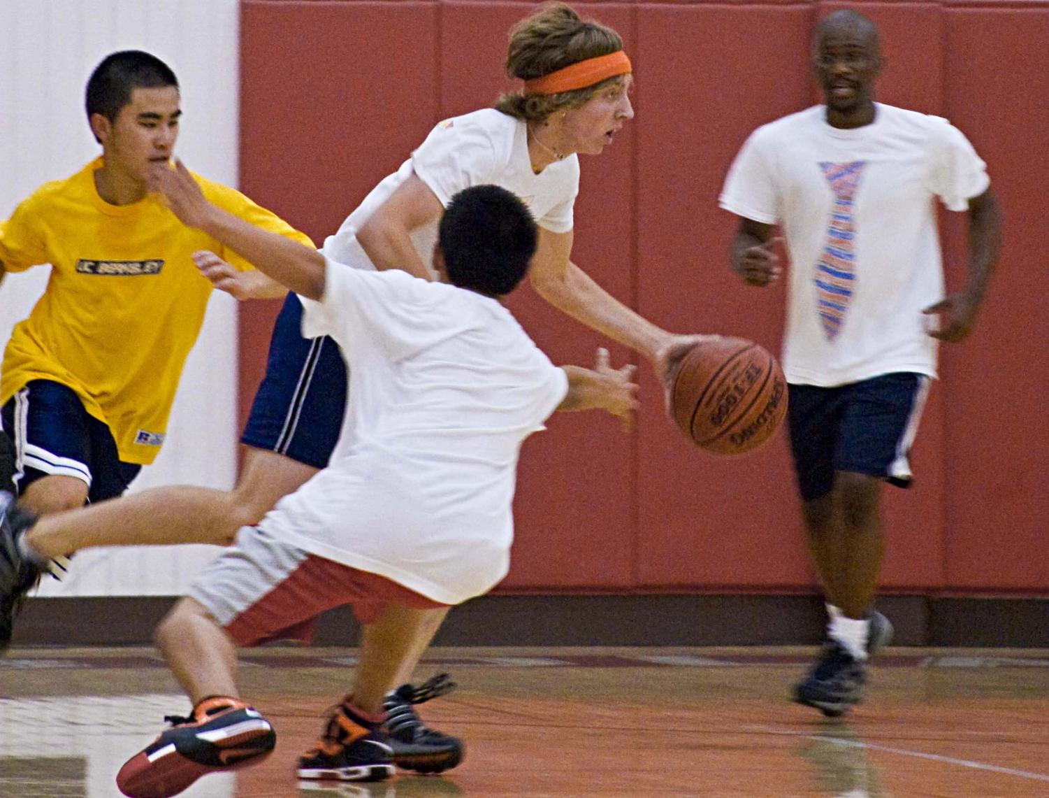 Point guard of the Serious Business team fights off the Banana Warriors team members. Banana Warriors won their playoff game Tuesday night.