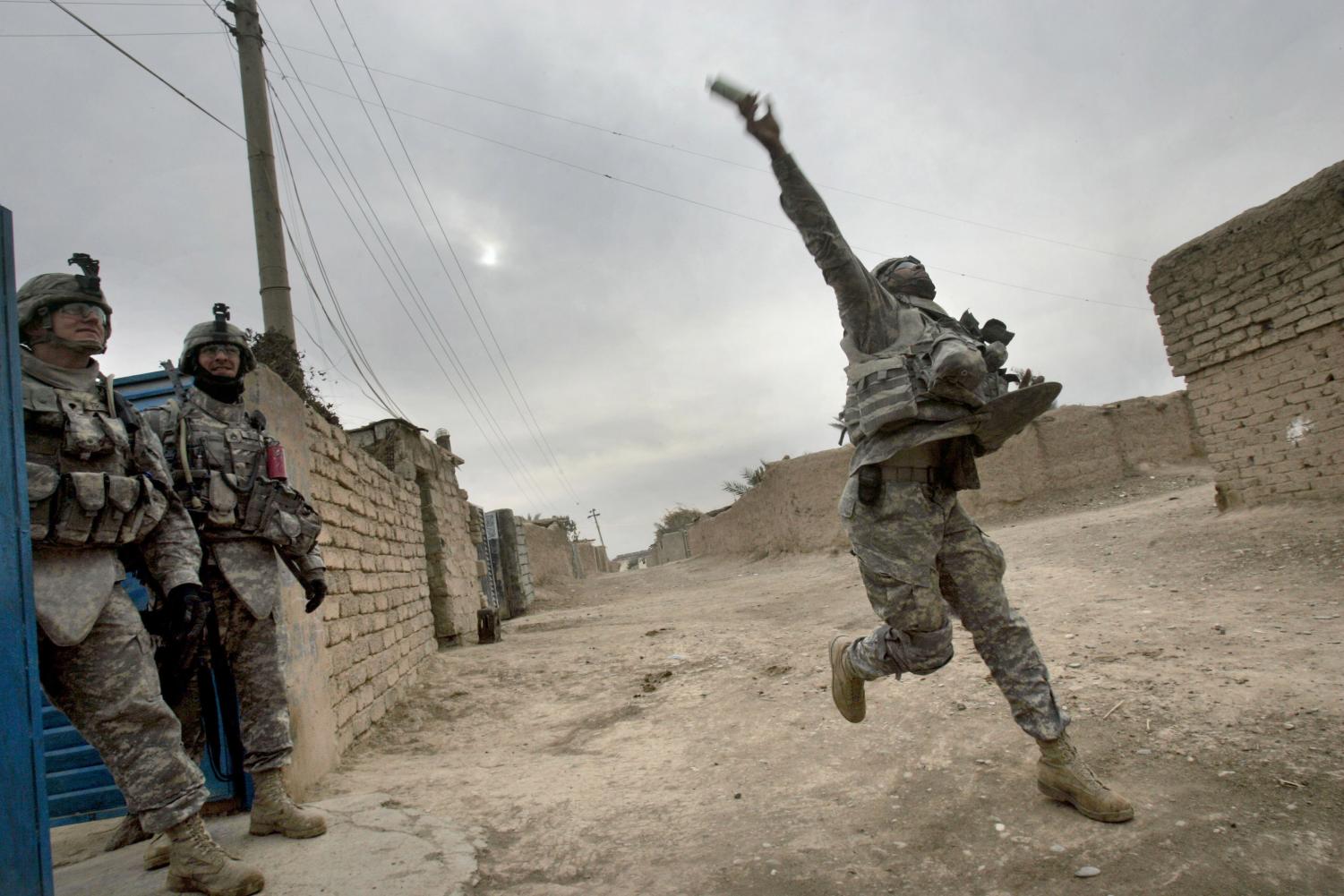 A U.S. army soldier from the Ghostrider Company, 3rd Squadron, 2nd Stryker Cavalry Regiment throws a smoke grenade during Operation Phantom Phoenix in the village of Abu Musa on the northern outskirts of Muqdadiyah, in the volatile Diyala province, about 90 kilometers (60 miles) north of Baghdad, Iraq, Thursday, Jan. 10, 2008.