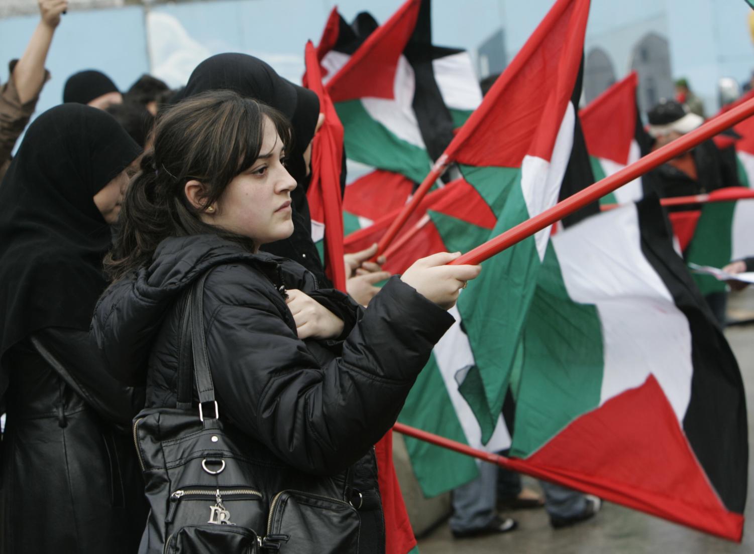 Lebanese Hezbollah students, wave Palestinian flags, in front of the United Nations house, Beirut, Lebanon, Wednesday, Jan. 23, 2008, during a protest about the latest developments on the Rafah border crossing between Egypt and the Gaza Strip.