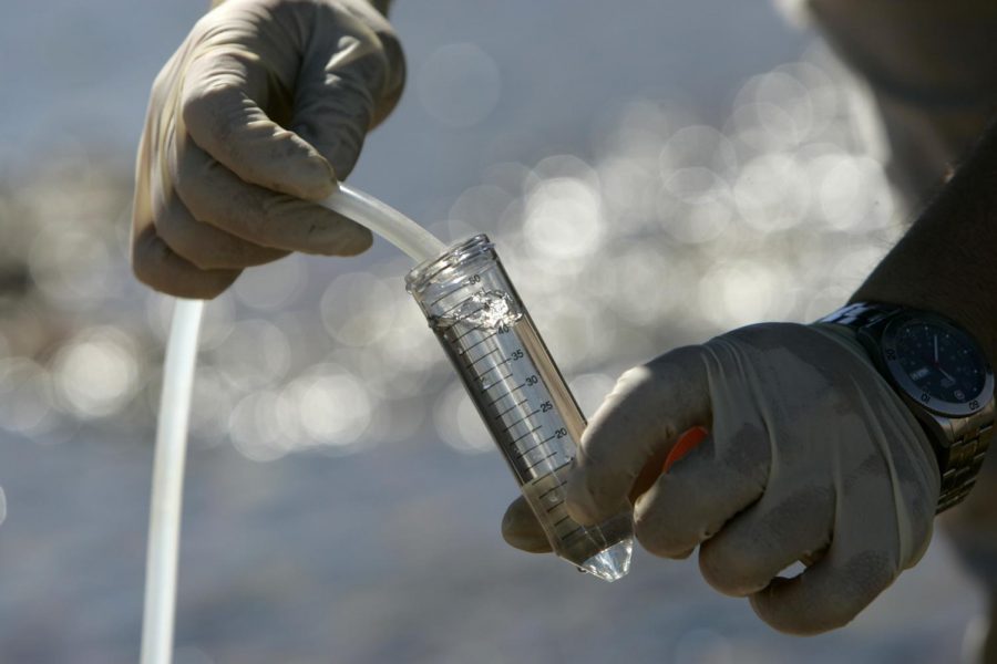 Duane Moser, an assistant research professor with Desert Research Institute, collects water samples from the Las Vegas Wash in Henderson, Nev., Thursday, Oct. 18, 2007.