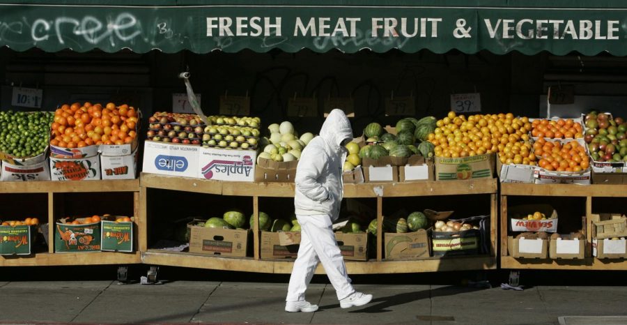 A man walks by a fruit stand on a chilly morning in San Francisco, Tuesday, Jan. 1, 2008.