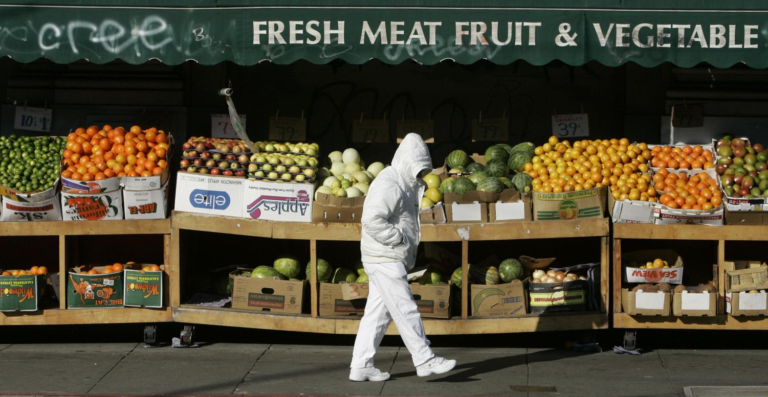 A man walks by a fruit stand on a chilly morning in San Francisco, Tuesday, Jan. 1, 2008.