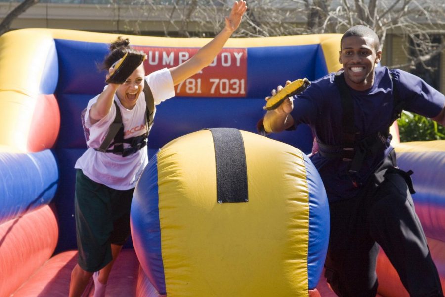 Kelsey Erickson and Ralph Miley play in competition on the Jump N' Joy, the carnival game set up by the track and field team.