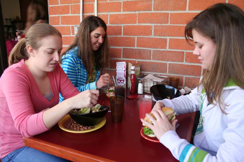 Biola+freshmen+Jessica+White%2C+Laura+Dahl%2C+and+Stephanie+Wilkerson+reunite+after+the+winter+break+while+eating+lunch+together+in+the+cafeteria.