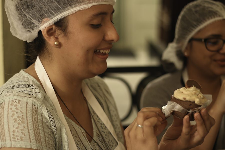 Senior nursing major Linda Venegas eats one of her cupcakes.