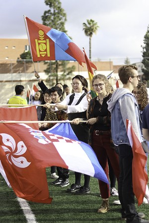 Students waving national flags