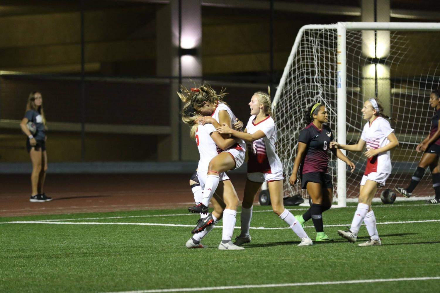 Junior forward AnnMarie Alvarez celebrates with Sarah Jeffries and Colie Martin after scoring the game-winning goal