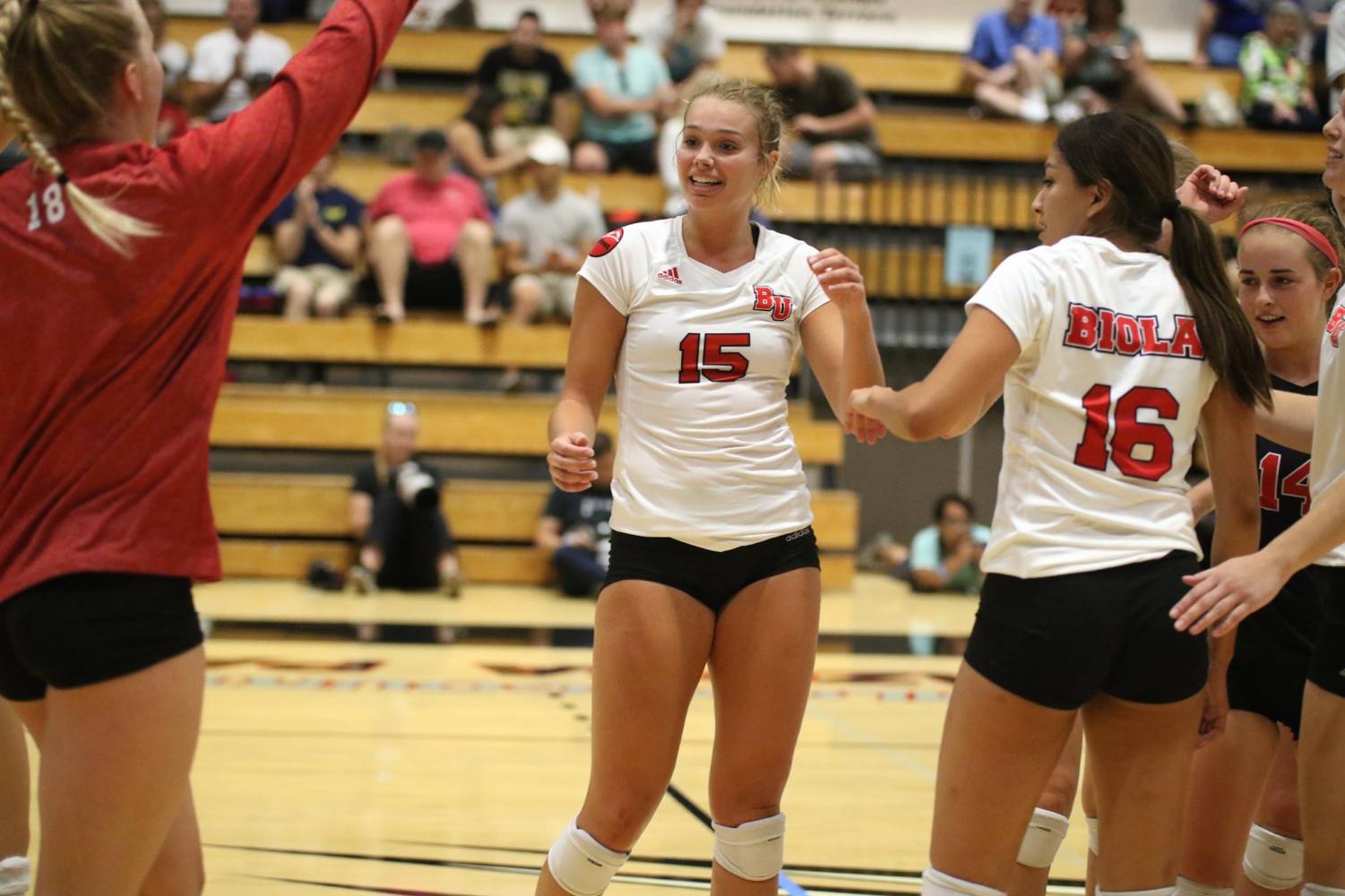 Sophomore outside hitter Christina DenBoer celebrates with her team in the gym