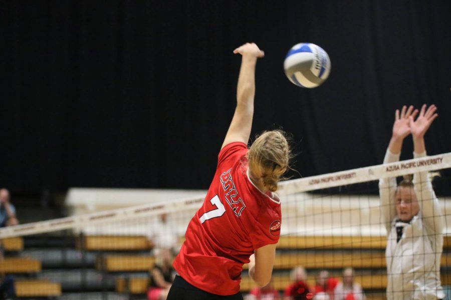 Karly Dantuma stretches her hand toward the ball as it flies over the net