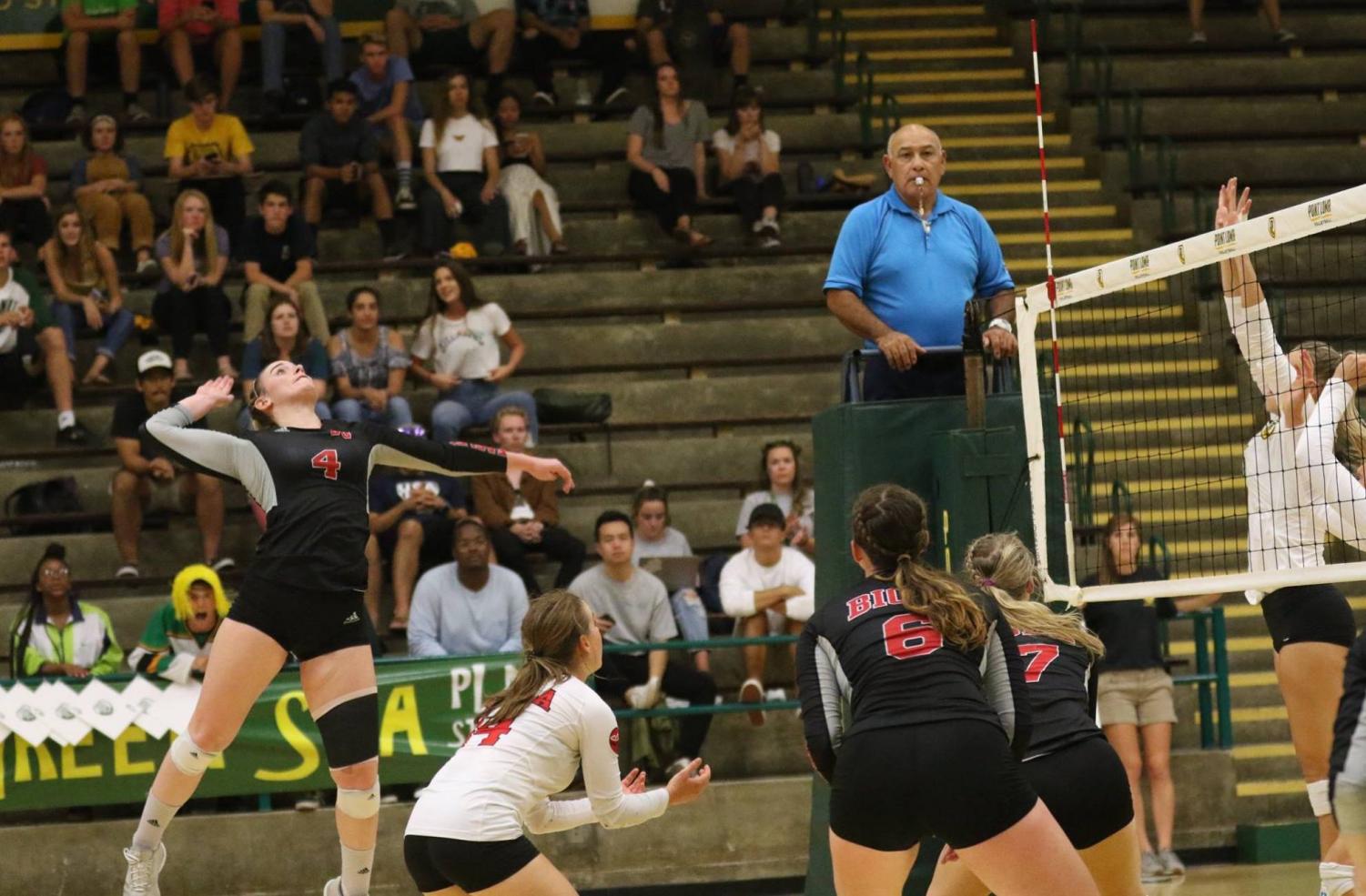 Junior outside hitter Sabrina Winslow readies for a kill while teammates look on during the Eagles' game at Point Loma on Sept. 11.