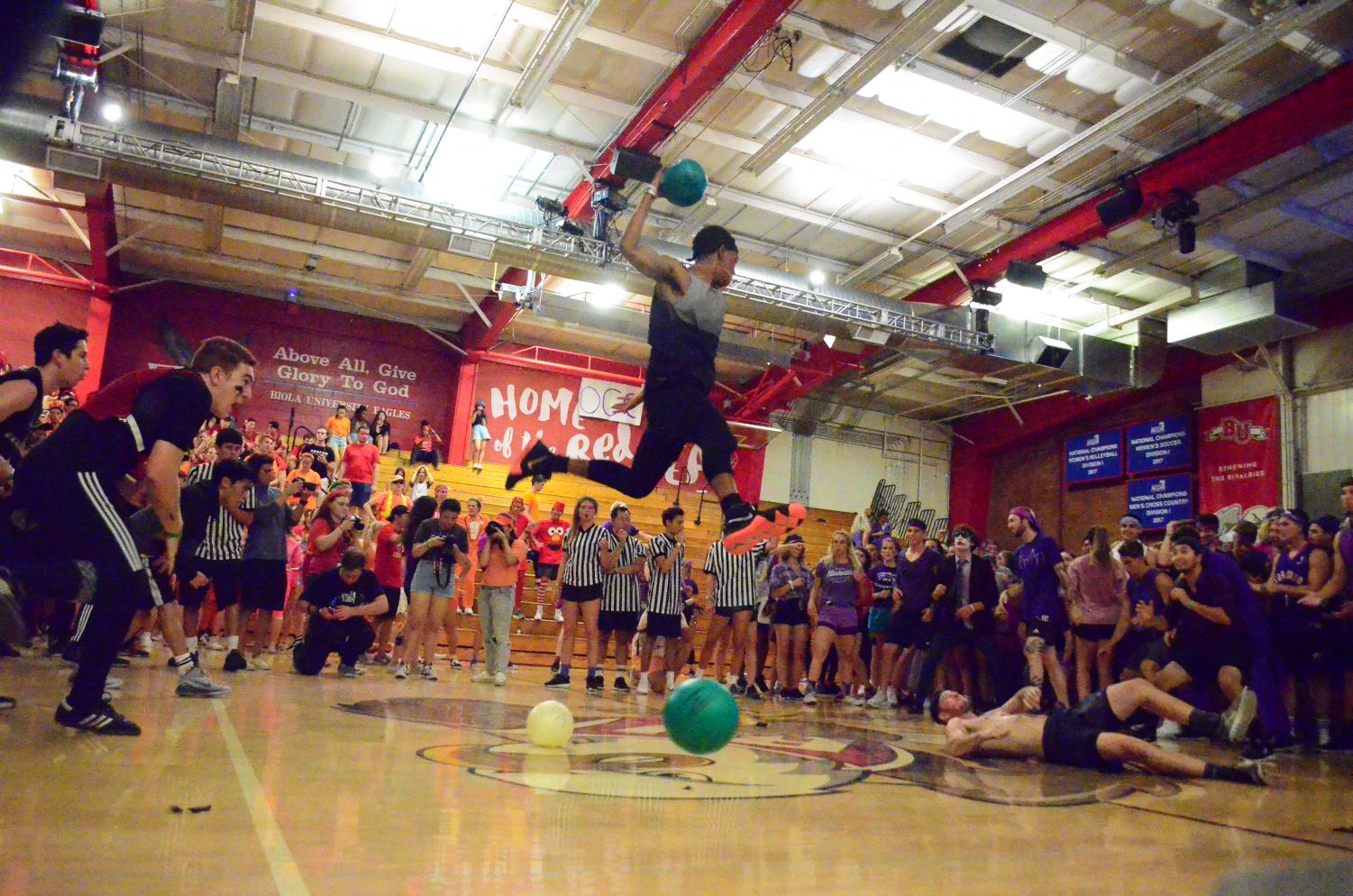 A horton resident leaps into the air with a dodgeball toward the off-campus community students