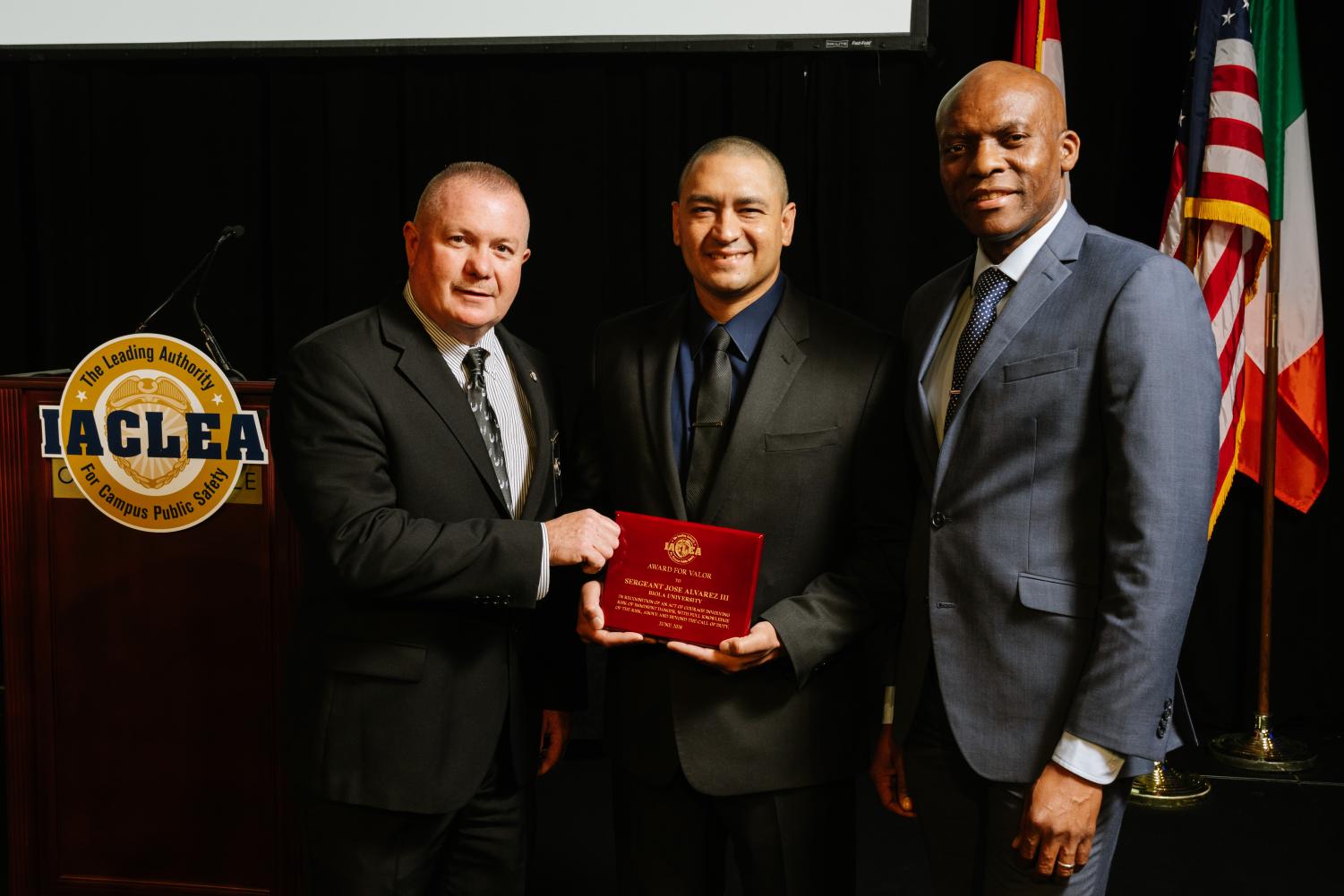 Sgt. Alvarez receiving his award alongside Chief John Ojeisekhoba