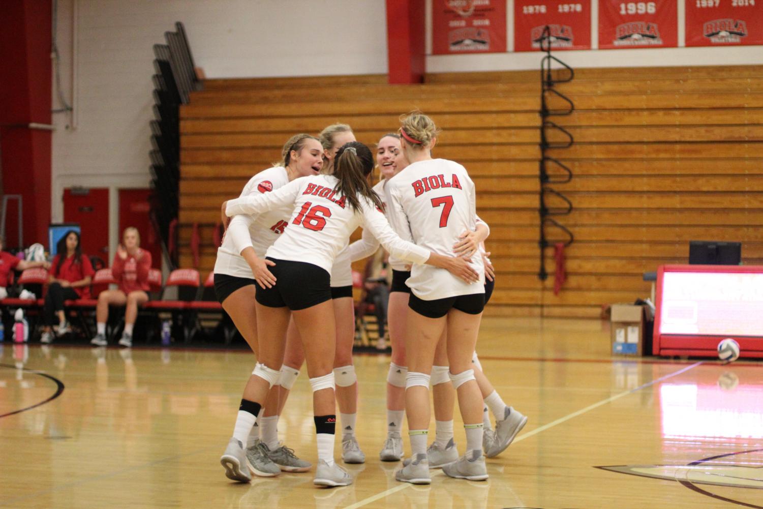 Biola volleyball players celebrate a point during their sweep of Chaminade University on Sept. 17, 2018. Photo by Aaron Zhang/THE CHIMES