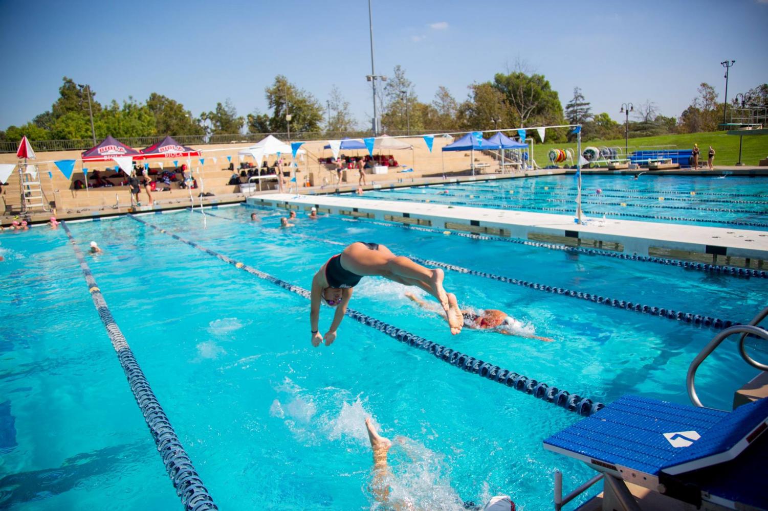 An Eagles swimmer leaps into the pool during the Pacific Coast Swim Conference relays on Oct. 6, 2018.