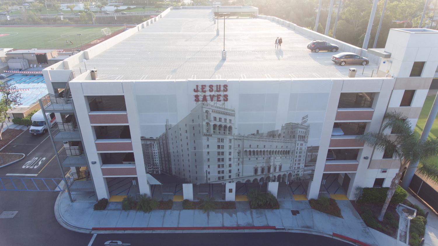 Photo depicts a birds eye view drone image of the Jesus Saves Parking Structure