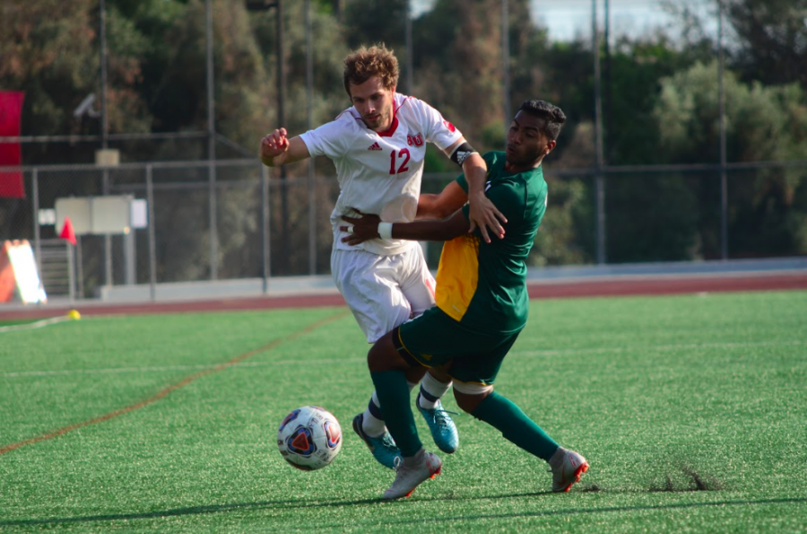 Senior defender Parker Setran battles for a loose ball during Biolas game against Concordia University Irvine on Oct. 6, 2018. Photo by Abram Hammer / THE CHIMES