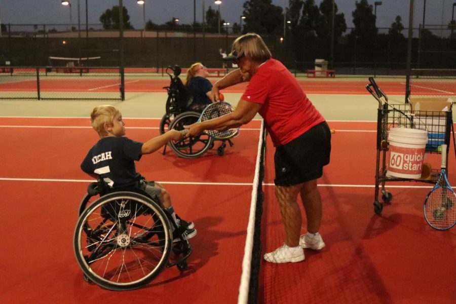 Tennis coach Dee Henry instructs her athlete.