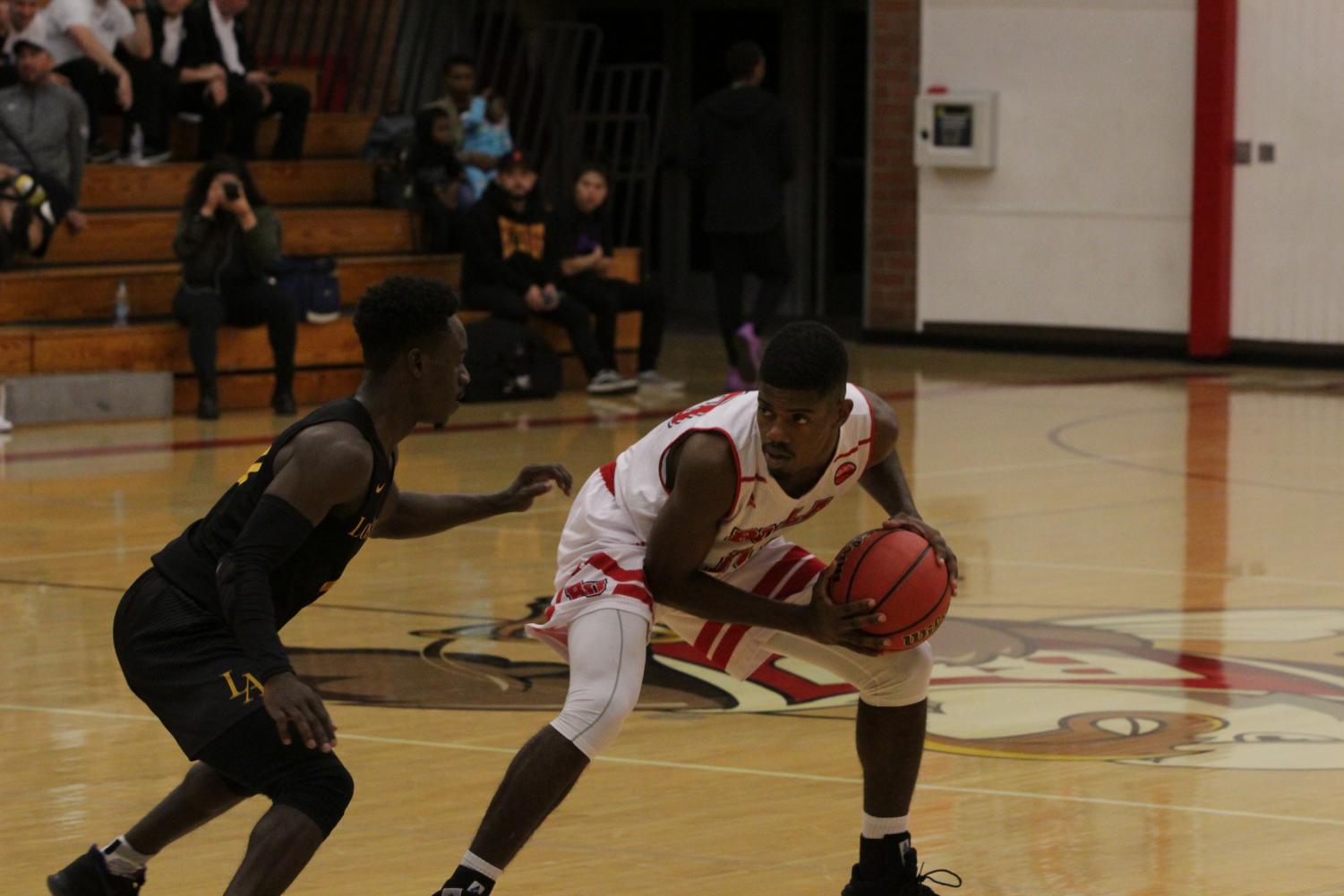 Point guard Alex Wright handles the ball during a home game against West Coast Baptist on Nov. 13, 2018. The Eagles won, 99-68, behind Alex Talma's 24-point double-double.