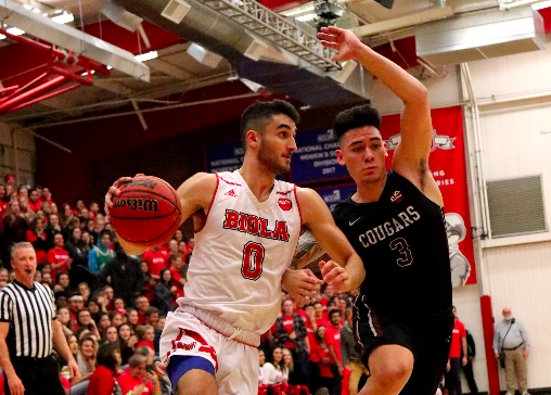 Sophomore guard Michael Bagatourian dribbles through the court in a game against Azusa Pacific University on Dec. 15.