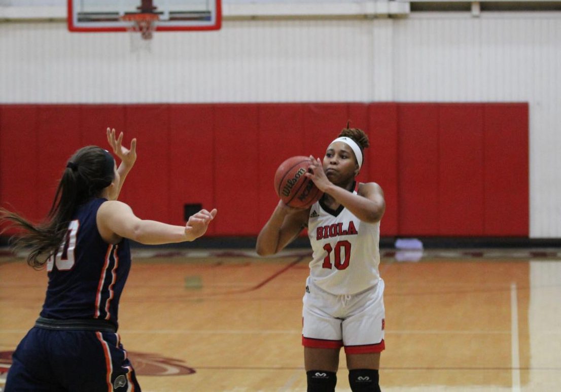 #10 student prepares to shoot a basketball