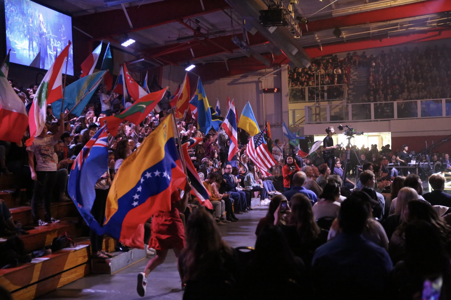 students wave country flags for missions conference