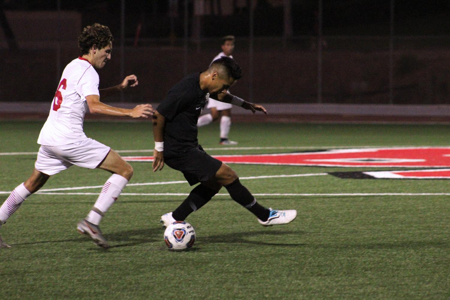 Freshman midfielder Chad Sinclair attempts to steal the ball from his opponent, during the game against California State University San Marcos on September 11, 2019. 